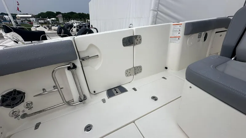 Slide: The Image of 2025 Boston Whaler 330 Outrage boat interior with seating and stainless steel fixtures. - 14