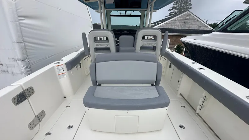 Slide: The Image of 2025 Boston Whaler 330 Outrage boat interior with gray seating and modern design. - 15