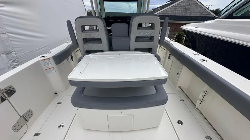 Slide: The Image of 2025 Boston Whaler 330 Outrage boat interior with seating and table. - 16