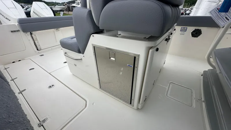 Slide: The Image of 2025 Boston Whaler 330 Outrage interior with seating and storage compartment. - 19