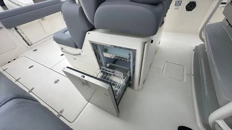 Slide: The Image of 2025 Boston Whaler 330 Outrage interior with open storage compartment. - 20