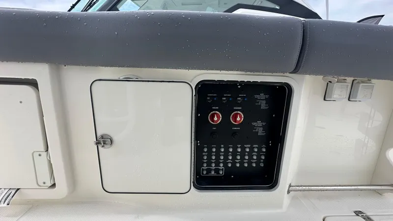 Slide: The Image of 2025 Boston Whaler 330 Outrage control panel with switches and dials, featuring a sleek design. - 22