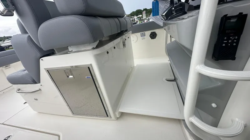 Slide: The Image of 2025 Boston Whaler 330 Outrage interior with seating and storage compartments. - 23