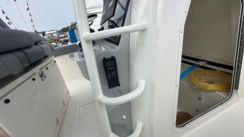 Slide: The Image of 2025 Boston Whaler 330 Outrage interior with seating, storage, and equipment. - 26
