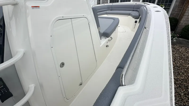 Slide: The Image of 2025 Boston Whaler 330 Outrage boat interior with seating and storage compartment. - 27