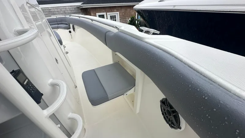 Slide: The Image of 2025 Boston Whaler 330 Outrage boat interior with gray seating and wet surfaces. - 29