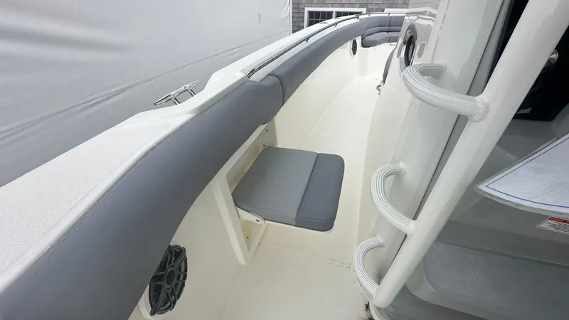 Slide: The Image of 2025 Boston Whaler 330 Outrage boat interior with seating and handrails. - 30