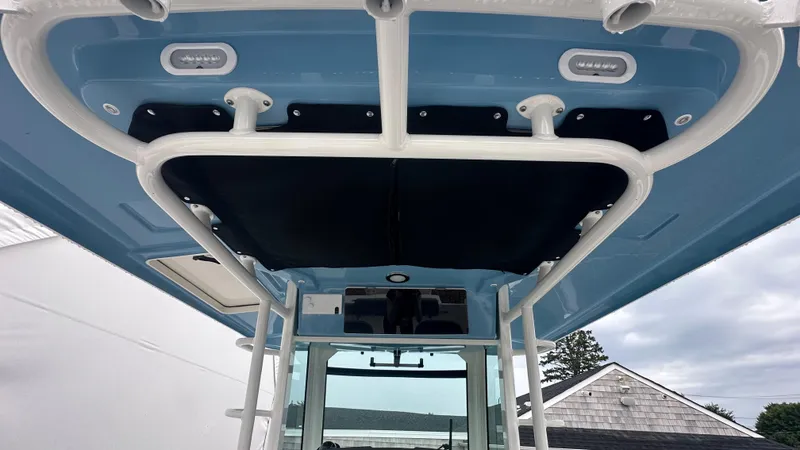 Slide: The Image of 2025 Boston Whaler 330 Outrage boat canopy with blue and black detailing. - 32
