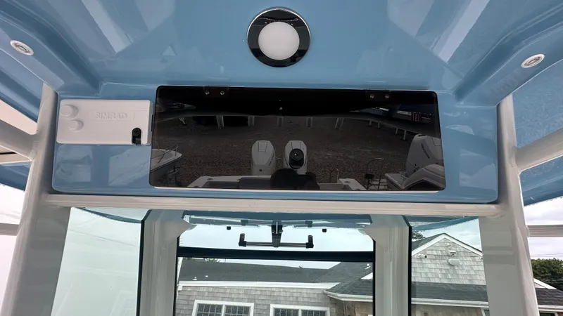 Slide: The Image of 2025 Boston Whaler 330 Outrage helm with Simrad electronics and blue overhead panel. - 33