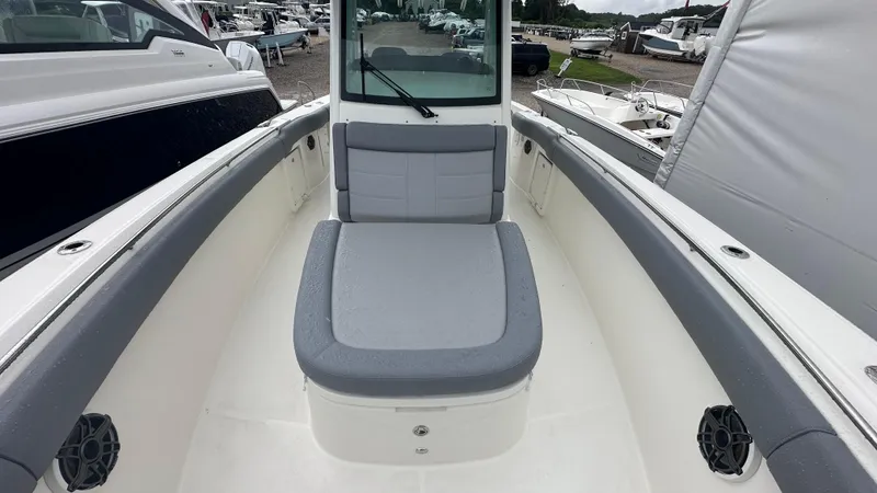 Slide: The Image of 2025 Boston Whaler 330 Outrage boat interior with cushioned seating and sleek design. - 35