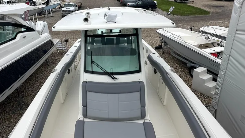 Slide: The Image of 2025 Boston Whaler 330 Outrage boat, top view, showcasing spacious deck and seating. - 37