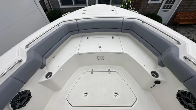 Slide: The Image of 2025 Boston Whaler 330 Outrage boat interior with gray seating and storage compartments. - 39