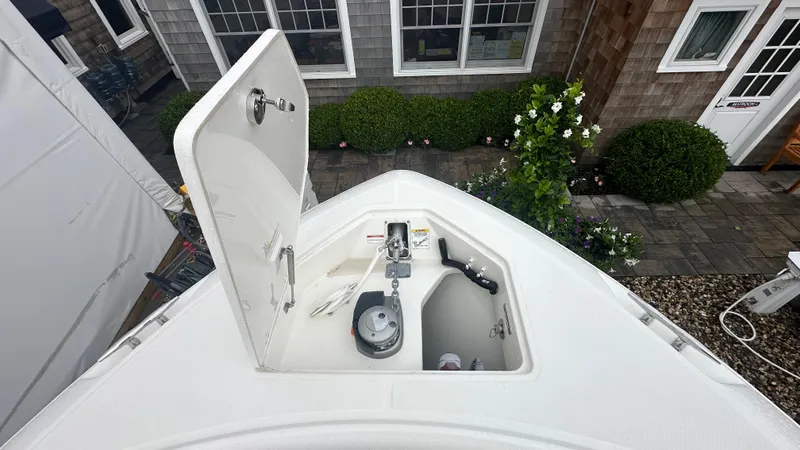 Slide: The Image of 2025 Boston Whaler 330 Outrage anchor locker, open, showing anchor and chain storage. - 40