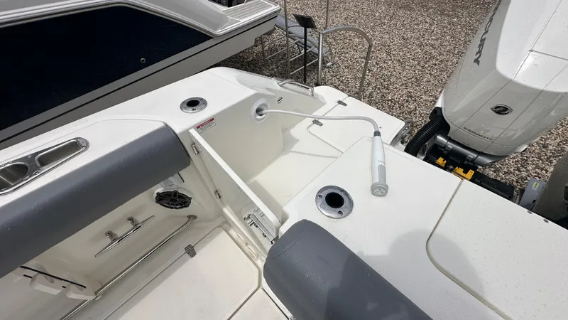Slide: The Image of 2025 Boston Whaler 330 Outrage boat deck with seating and engine view. - 6