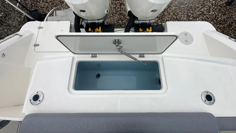 Slide: The Image of 2025 Boston Whaler 330 Outrage livewell and dual outboard motors. - 9
