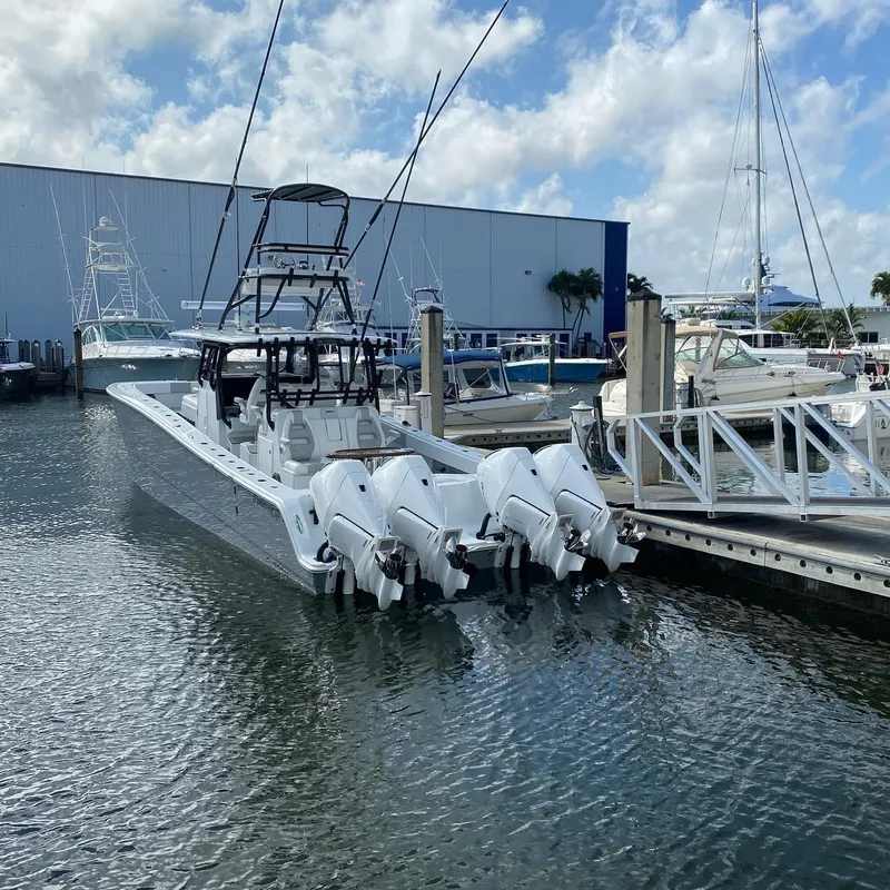 The Image of 2021 Freeman 42 LR boat docked with multiple outboard engines, marina background. - 0