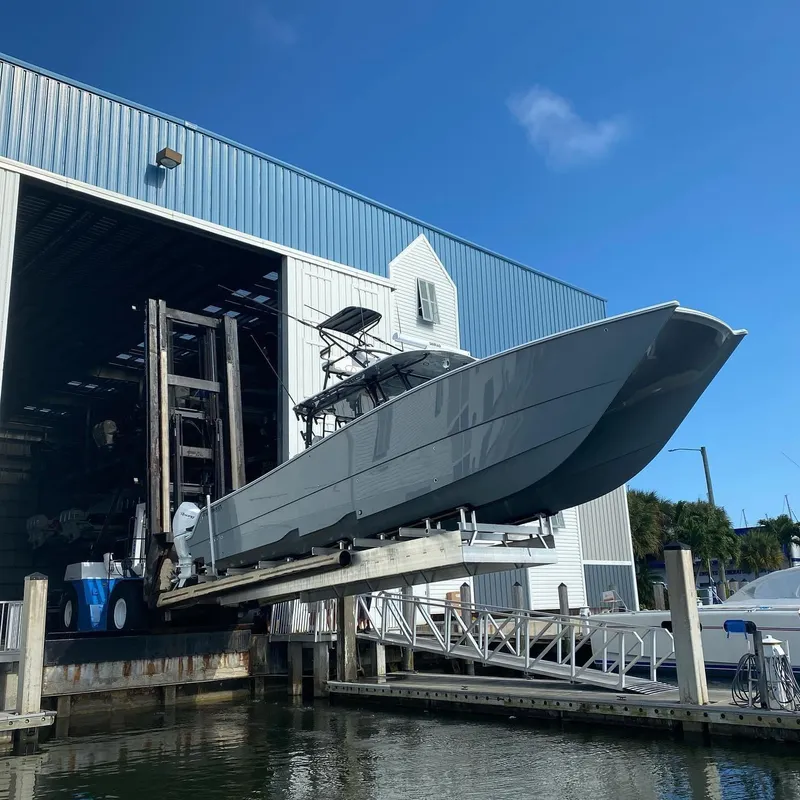 Slide: The Image of Freeman 42 LR boat being launched from a marina storage facility, 2021 model. - 1