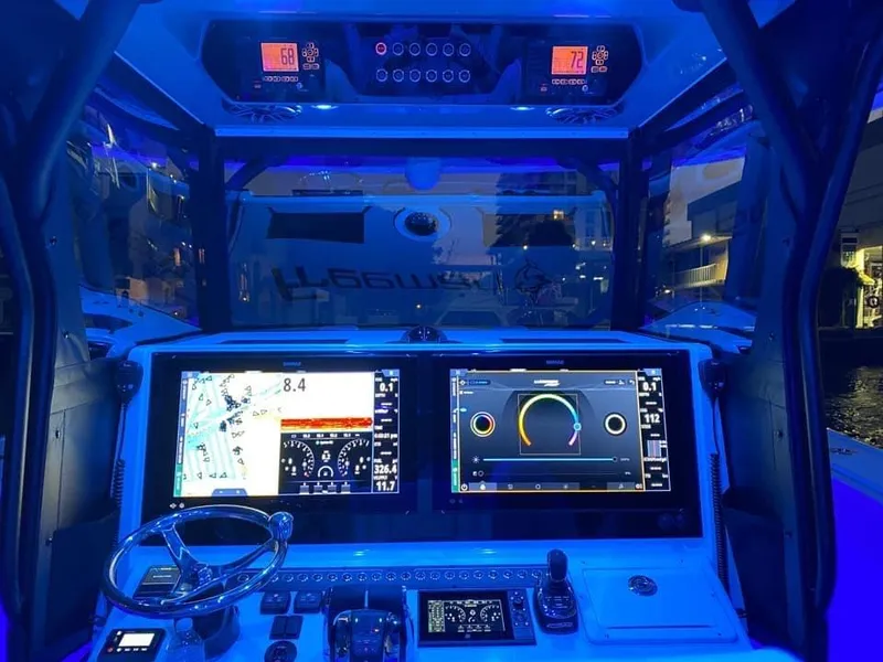 Slide: The Image of Freeman 42 LR 2021 boat cockpit with illuminated navigation screens and controls at night. - 11