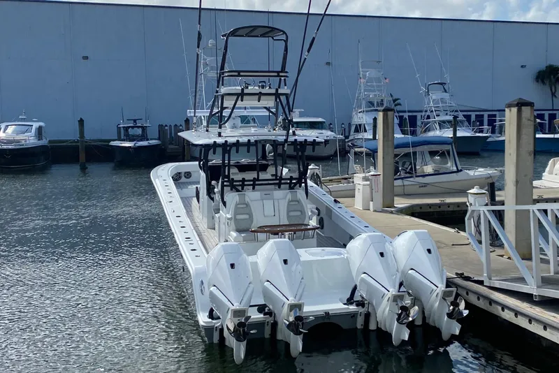 Slide: The Image of Freeman 42 LR 2021 boat docked with four outboard engines. - 14