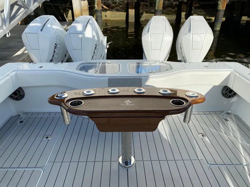 Slide: The Image of Freeman 42 LR 2021 boat deck with fishing rod holders and powerful engines. - 6