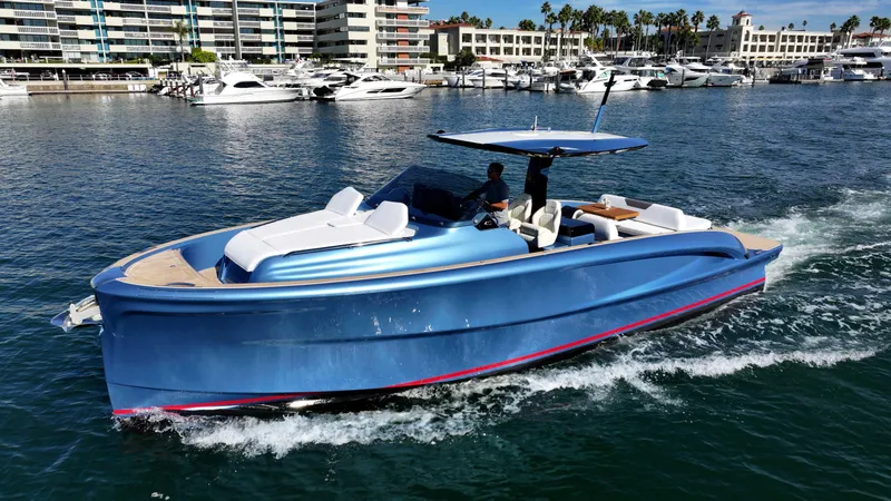 Slide: The Image of 2023 Solaris Power 40 Open yacht cruising in a marina with modern buildings in the background. - 5
