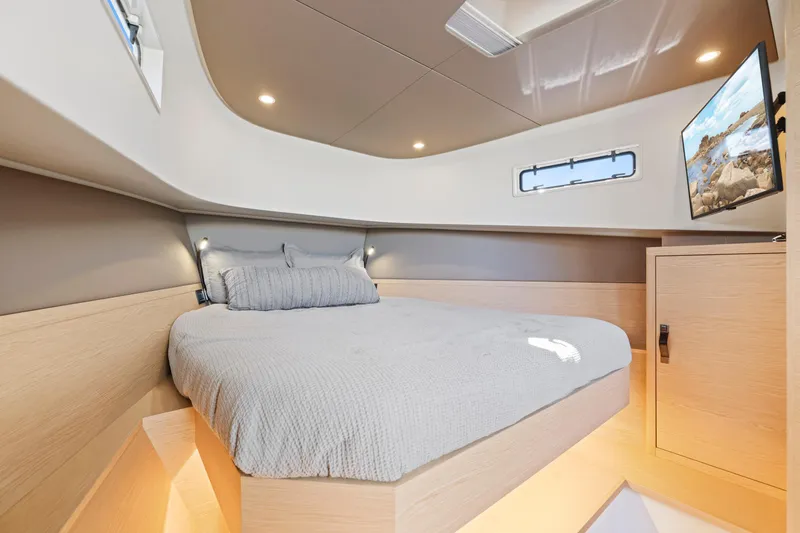 Slide: The Image of Luxurious cabin interior of 2023 Solaris Power 40 Open yacht, featuring modern design and cozy bedding. - 25