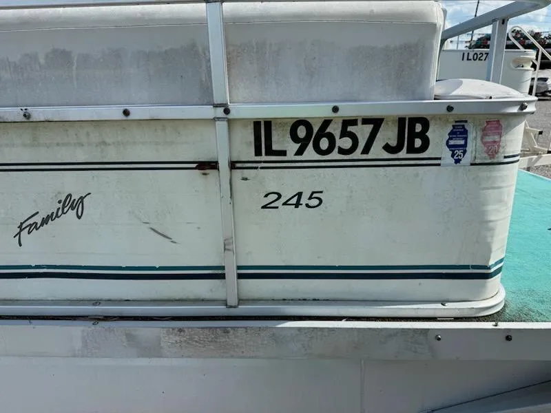 Slide: The Image of 1998 Lowe Family 245 boat with registration IL 9657 JB, docked. - 2