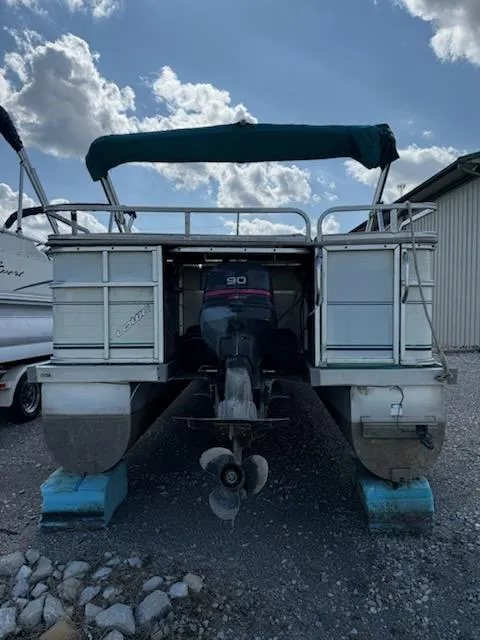 Slide: The Image of 1998 Lowe Family 245 pontoon boat with canopy, docked on land. - 5