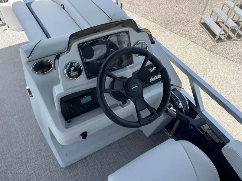 Slide: The Image of Steering console of 2025 Avalon 2385 Venture 85 Quad Lounger boat, featuring modern controls. - 10