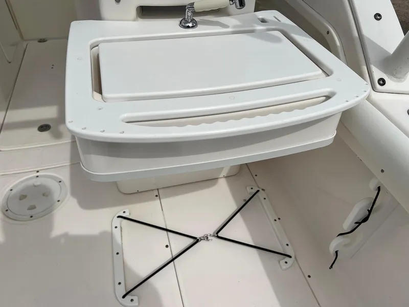 Slide: The Image of Everglades 230 Dual Console 2013 boat interior with white storage compartment and sink. - 14