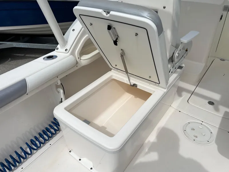 Slide: The Image of Open storage compartment on 2013 Everglades 230 Dual Console boat interior. - 15