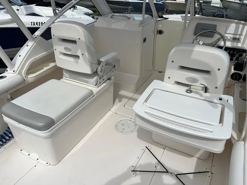 Slide: The Image of 2013 Everglades 230 Dual Console boat interior with seating and helm. - 17