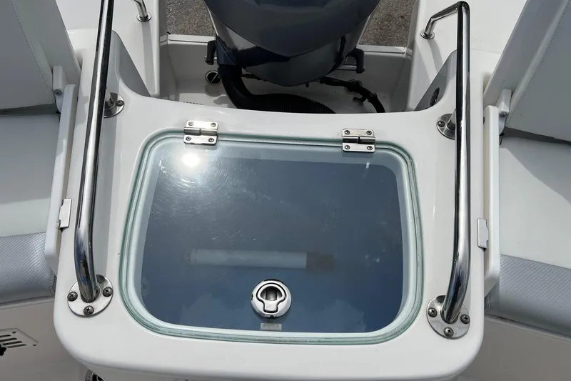 Slide: The Image of Livewell on a 2013 Everglades 230 Dual Console boat, featuring stainless steel rails. - 19