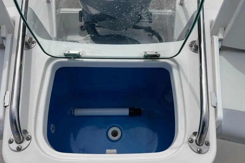 Slide: The Image of Livewell on 2013 Everglades 230 Dual Console boat with glass cover and stainless steel handles. - 20