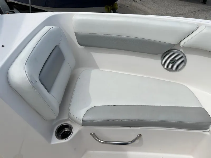 Slide: The Image of 2013 Everglades 230 Dual Console boat interior seating with cup holder and speaker. - 3