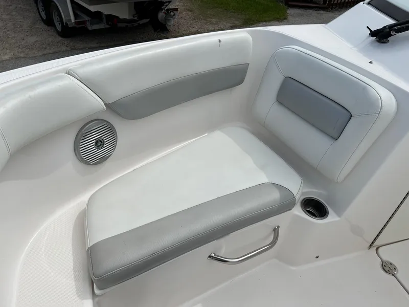 Slide: The Image of 2013 Everglades 230 Dual Console boat interior seating with speaker and cup holder. - 4
