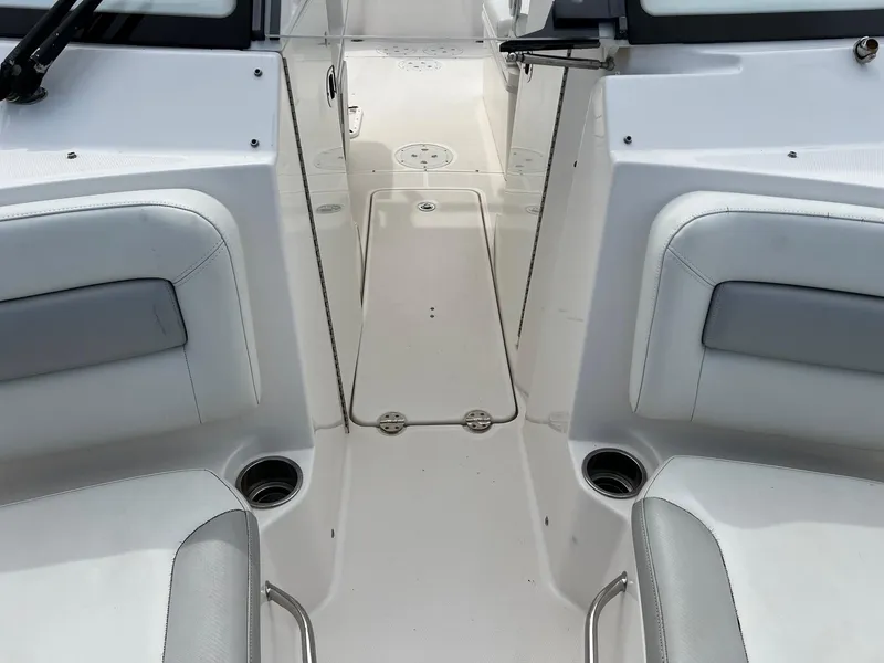 Slide: The Image of 2013 Everglades 230 Dual Console boat interior with seating and cup holders. - 5