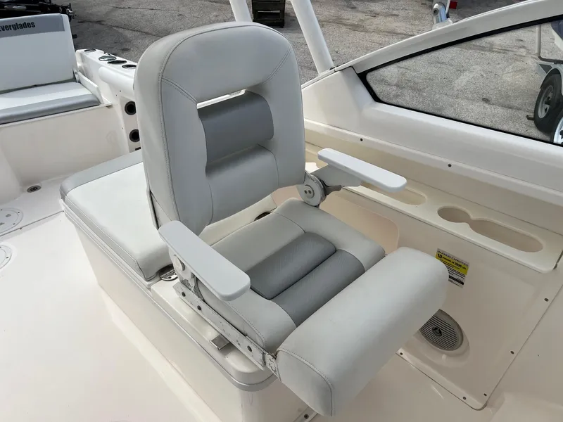 Slide: The Image of Captain's chair on 2013 Everglades 230 Dual Console boat, featuring cushioned armrests and sleek design. - 7