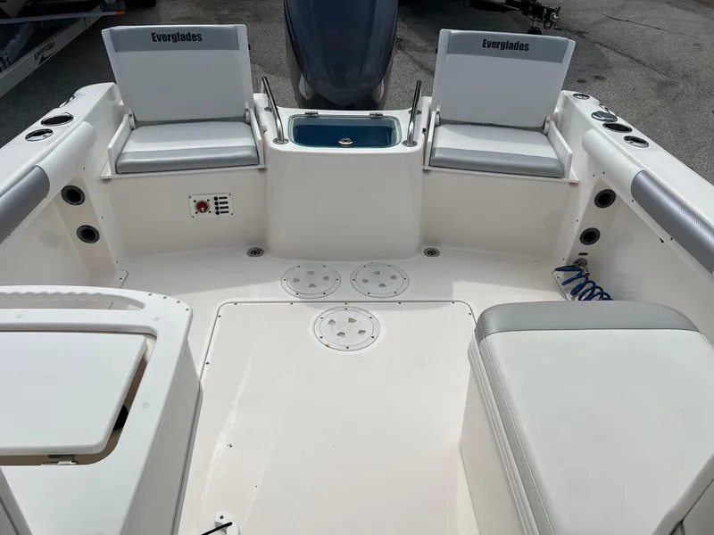 Slide: The Image of 2013 Everglades 230 Dual Console boat interior with seating and storage compartments. - 8