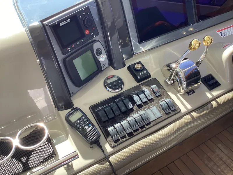 Slide: The Image of Control panel of a 2006 Sea Ray 48 Sundancer yacht with navigation equipment. - 12