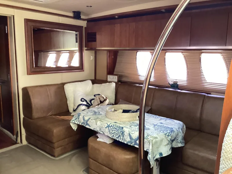 Slide: The Image of Interior of 2006 Sea Ray 48 Sundancer yacht with cozy seating and nautical decor. - 13
