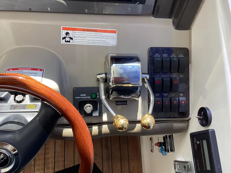 Slide: The Image of Control panel of a 2006 Sea Ray 48 Sundancer yacht with throttle and switches. - 17