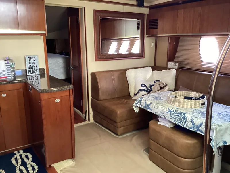 Slide: The Image of Interior of 2006 Sea Ray 48 Sundancer yacht with cozy seating and nautical decor. - 18