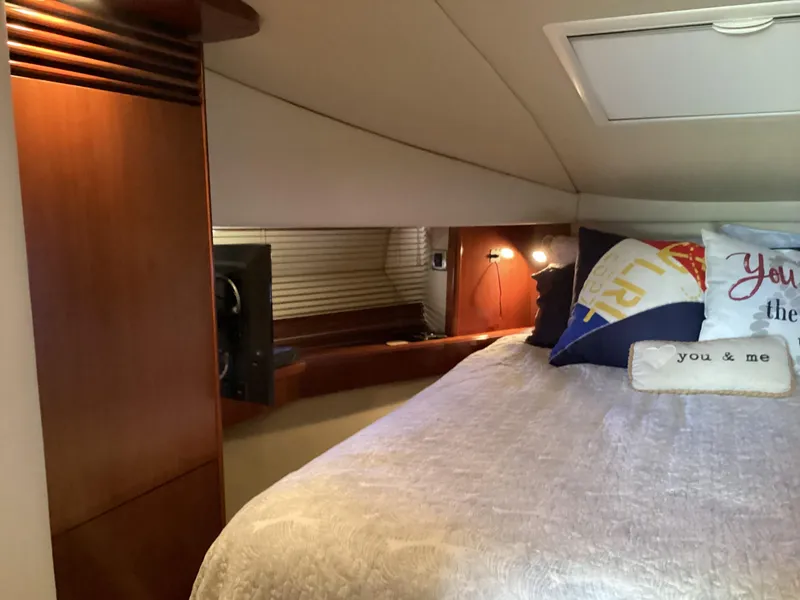 Slide: The Image of Cozy bedroom interior of 2006 Sea Ray 48 Sundancer yacht with pillows and warm lighting. - 19