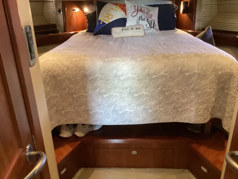 Slide: The Image of Cozy bedroom interior of 2006 Sea Ray 48 Sundancer yacht with decorative pillows. - 20