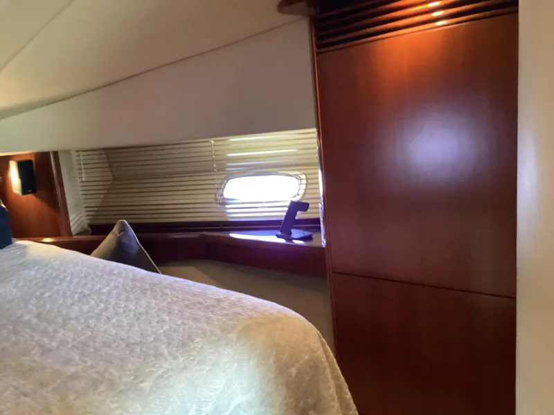 Slide: The Image of Interior cabin of 2006 Sea Ray 48 Sundancer yacht with wooden paneling and window. - 21