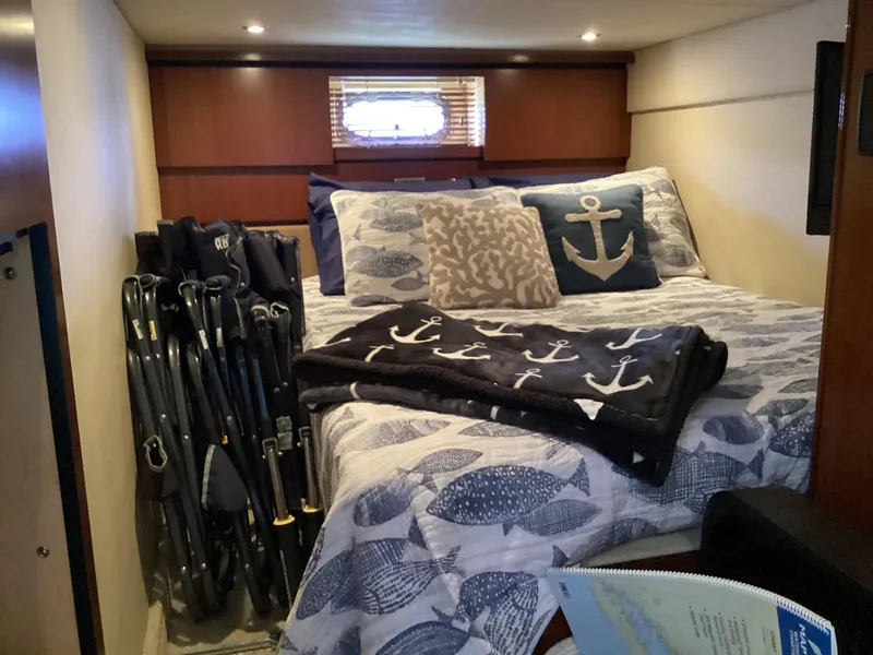 Slide: The Image of Cozy cabin interior of 2006 Sea Ray 48 Sundancer with nautical-themed bedding. - 25