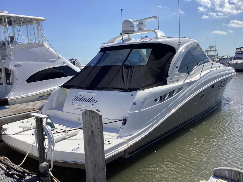Slide: The Image of 2006 Sea Ray 48 Sundancer yacht docked at marina under clear blue sky. - 3