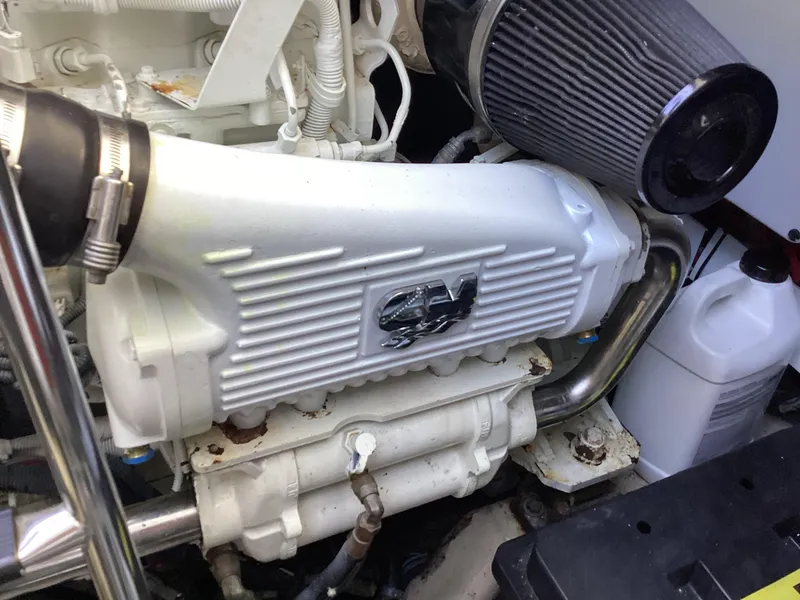 Slide: The Image of Engine compartment of a 2006 Sea Ray 48 Sundancer boat, featuring a white engine component. - 32