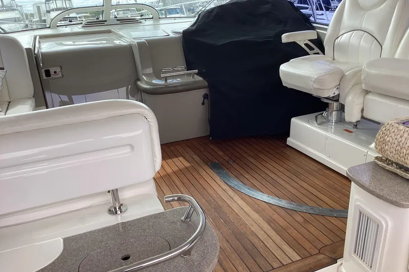 Slide: The Image of 2006 Sea Ray 48 Sundancer interior with wooden flooring and white seating. - 36